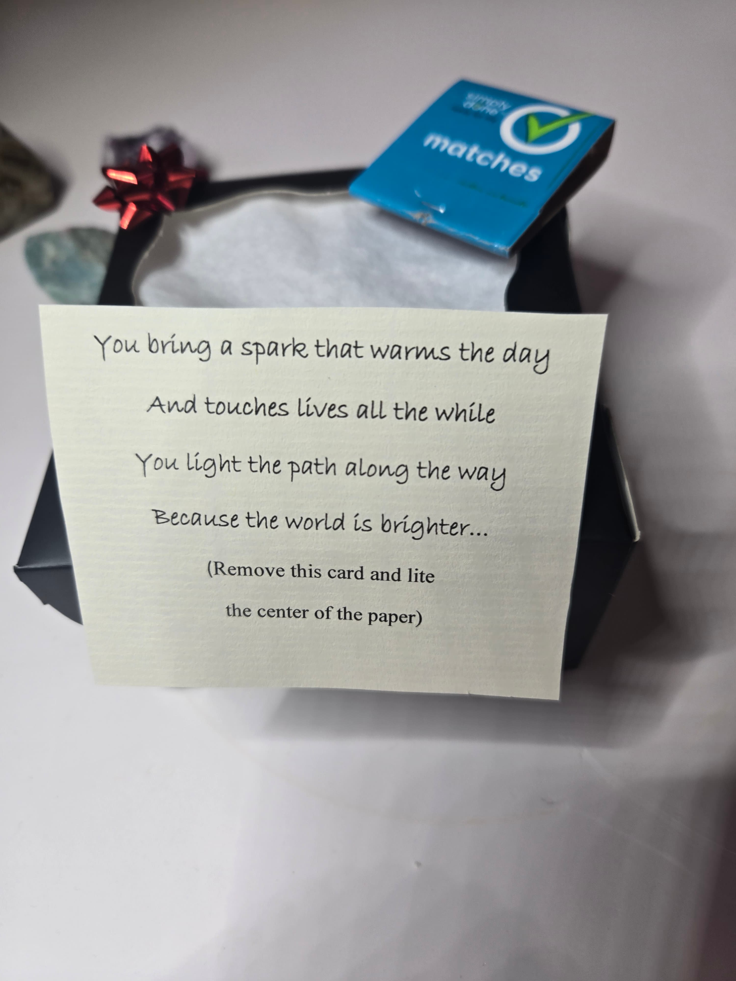 Open Smile in a Box with the poem card, matches, and gift bow